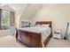 Bedroom featuring a large, wooden-framed bed, window seat, and built-in bookshelves at 2019 Ye Olde Kings Hwy., North Myrtle Beach, SC 29582