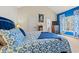Comfortable bedroom showcasing blue accents and a window with bright blue curtains and an interesting print at 2019 Ye Olde Kings Hwy., North Myrtle Beach, SC 29582