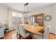 Bright dining room with a large window, hardwood floors, modern lighting, and stylish seating for six at 2019 Ye Olde Kings Hwy., North Myrtle Beach, SC 29582