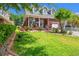 Charming brick home featuring a manicured lawn, beautiful landscaping, and a welcoming front porch with rocking chairs at 2019 Ye Olde Kings Hwy., North Myrtle Beach, SC 29582