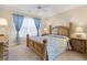 Bedroom with a ceiling fan, a bed with side tables, and a dresser with decorative items at 202 Glenwood Dr., Conway, SC 29526