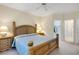 Bedroom with a wooden bed, side tables with lamps, and doorways to the closet and bathroom at 202 Glenwood Dr., Conway, SC 29526