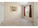 Simple bedroom featuring a window with maroon curtains, carpet flooring, and an art piece at 202 Glenwood Dr., Conway, SC 29526