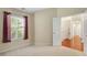 Bright bedroom featuring a window with curtains, carpet flooring, and a doorway to a living area at 202 Glenwood Dr., Conway, SC 29526