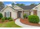 Close-up of a well-kept home entrance with decorative landscaping and brick and vinyl siding at 202 Glenwood Dr., Conway, SC 29526