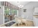 Eat-in kitchen with white cabinetry, modern lighting, and sliding doors to the porch at 202 Glenwood Dr., Conway, SC 29526