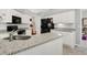 Kitchen boasts granite countertops, white cabinetry, and modern black appliances at 202 Glenwood Dr., Conway, SC 29526