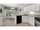 Bright eat-in kitchen features white cabinets and stainless steel appliances with access to porch at 202 Glenwood Dr., Conway, SC 29526