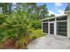 A cozy screen room adjoins a lovely paved patio and manicured landscaping at 202 Glenwood Dr., Conway, SC 29526