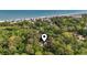 Aerial view of a coastal home nestled among lush trees with ocean views, offering privacy and serenity at 206 Dogwood Dr., Myrtle Beach, SC 29575