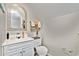 Charming powder room featuring a decorative mirror and a sink with a white vanity at 206 Dogwood Dr., Myrtle Beach, SC 29575