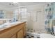 Unique bathroom featuring tiled vanity, glass block shower, and turtle themed curtain at 206 Dogwood Dr., Myrtle Beach, SC 29575