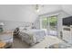 Comfortable bedroom with a queen bed, deck access, and coastal decor at 206 Dogwood Dr., Myrtle Beach, SC 29575