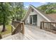 Expansive wooden deck featuring stairs, railings, and outdoor seating near trees at 206 Dogwood Dr., Myrtle Beach, SC 29575