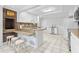 Bright, airy kitchen features counter seating, tile floors and white cabinets, perfect for entertaining at 206 Dogwood Dr., Myrtle Beach, SC 29575