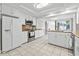 Spacious white kitchen with stainless steel appliances, tile flooring, and ample cabinet space at 206 Dogwood Dr., Myrtle Beach, SC 29575