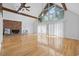 Open living space with hardwood floors, brick fireplace, exposed ceiling beams, and lots of natural light at 206 Dogwood Dr., Myrtle Beach, SC 29575