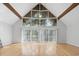 Bright living room featuring soaring windows, hardwood floors, and a vaulted ceiling with exposed beams at 206 Dogwood Dr., Myrtle Beach, SC 29575