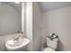 Clean half-bathroom with pedestal sink and a toilet topped with neatly folded towels at 264 Bolsin Ct, Conway, SC 29526