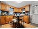 Cozy kitchen with wooden cabinets and a small table, perfect for casual dining at 2776 Holly Rd., Marion, SC 29571