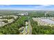 A scenic aerial view showcasing the community's tranquil setting with trees, lakes, and well-spaced homes at 3 Birdsong Ct., Murrells Inlet, SC 29576