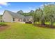 Backyard with palm tree and view of the home's exterior at 3 Birdsong Ct., Murrells Inlet, SC 29576