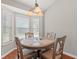 Cozy dining area with a round table, four chairs, and a bay window offering lots of natural light at 3 Birdsong Ct., Murrells Inlet, SC 29576