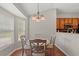 Dining area featuring a round table with seating for four, and large windows offering natural light at 3 Birdsong Ct., Murrells Inlet, SC 29576