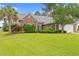 Well-maintained brick home with a lush green lawn and a mature palm tree in the front yard at 3 Birdsong Ct., Murrells Inlet, SC 29576