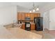 Functional kitchen featuring wooden cabinets, black appliances, and a practical layout at 3 Birdsong Ct., Murrells Inlet, SC 29576