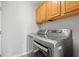 Laundry room featuring modern washer and dryer and wooden cabinets at 3 Birdsong Ct., Murrells Inlet, SC 29576