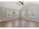Living room featuring high vaulted ceilings, a ceiling fan, and three large windows at 3 Birdsong Ct., Murrells Inlet, SC 29576