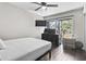 Bright bedroom with dark wood floors, natural light, and views of the surrounding nature at 306 Salt Marsh Circle # 5A, Pawleys Island, SC 29585
