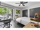 Bright bedroom with sleek, dark floors, modern décor, and a large window view at 306 Salt Marsh Circle # 5A, Pawleys Island, SC 29585