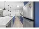 Spacious kitchen with stainless steel appliances and blue cabinetry. Large island with modern fixtures at 306 Salt Marsh Circle # 5A, Pawleys Island, SC 29585