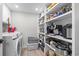 Organized laundry room with pantry shelving and modern washer and dryer set at 306 Salt Marsh Circle # 5A, Pawleys Island, SC 29585