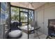 Relaxing screened porch with ceiling fan, outdoor furniture, and beautiful green views at 306 Salt Marsh Circle # 5A, Pawleys Island, SC 29585
