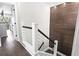 Modern staircase with wooden treads, white risers, and a unique wood-paneled accent wall at 306 Salt Marsh Circle # 5A, Pawleys Island, SC 29585
