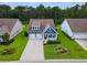 Charming two-story home with a well-manicured lawn and a three-car garage at 306 Southgate Ct., Pawleys Island, SC 29585