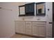 Bathroom with double sink vanity, framed mirrors, white cabinets, and tiled flooring at 306 Southgate Ct., Pawleys Island, SC 29585