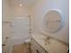 Bathroom featuring a vanity with a round mirror, a toilet, and a bathtub with a shower at 306 Southgate Ct., Pawleys Island, SC 29585