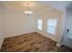 Open dining area featuring hardwood floors, a modern chandelier, and ample natural light at 306 Southgate Ct., Pawleys Island, SC 29585