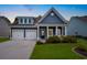 Charming blue home with a well-manicured lawn, a two-car garage, and a welcoming front porch at 306 Southgate Ct., Pawleys Island, SC 29585