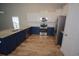 Stylish kitchen with granite countertops, stainless steel appliances, and custom blue and white cabinetry at 306 Southgate Ct., Pawleys Island, SC 29585