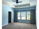Serene main bedroom with a tray ceiling, plush carpeting, and large windows with custom curtains at 306 Southgate Ct., Pawleys Island, SC 29585