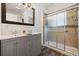 Bathroom featuring double vanity, shower with glass door, and wood flooring at 3565 Steamer Trace Rd., Conway, SC 29527