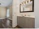 Bathroom with double sink vanity, large mirror, and hardwood floors at 3565 Steamer Trace Rd., Conway, SC 29527