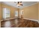 Spacious bedroom with wood floors, ceiling fan, two windows, and an ensuite bathroom at 3565 Steamer Trace Rd., Conway, SC 29527