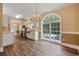 Dining room featuring wood floors, modern lighting, and a large picture window at 3565 Steamer Trace Rd., Conway, SC 29527