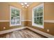 Dining room with hardwood floors, chandelier, and two windows overlooking a backyard at 3565 Steamer Trace Rd., Conway, SC 29527